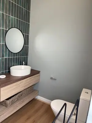 a bathroom with a sink and a toilet and a mirror at Gratia et Pax in Dullstroom
