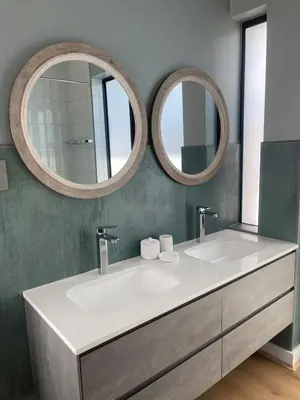 a bathroom with two sinks and two mirrors at Gratia et Pax in Dullstroom