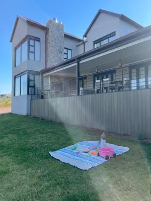 a child playing with a toy on a blanket in the yard at Gratia et Pax in Dullstroom