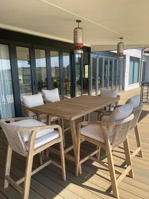 a wooden table and chairs on a deck at Gratia et Pax in Dullstroom