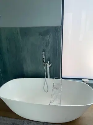 a white bath tub with a faucet in a bathroom at Gratia et Pax in Dullstroom