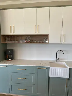 a kitchen with white cabinets and a sink at Gratia et Pax in Dullstroom