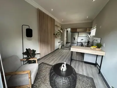a living room with a couch and a table at Crown on Milner in Pretoria