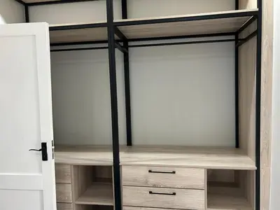 a closet with glass doors and wooden drawers at Crown on Milner in Pretoria