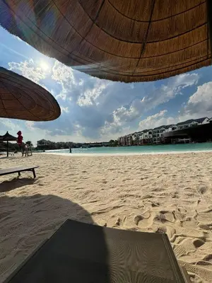 a view of a beach with an umbrella and the ocean at The Dream Escape At The Blyde - One Bedroom Apartment in Pretoria