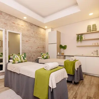 a bedroom with two beds with green and white pillows at The Dream Escape At The Blyde - One Bedroom Apartment in Pretoria