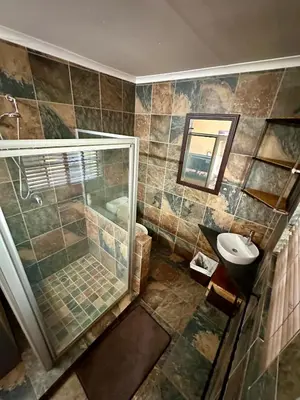a bathroom with a shower and a sink at Sky blue in Polokwane