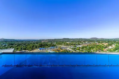 an overhead view of a large blue building with a city at #AlimamaSpaces Manson's Menlyn Maine in Pretoria