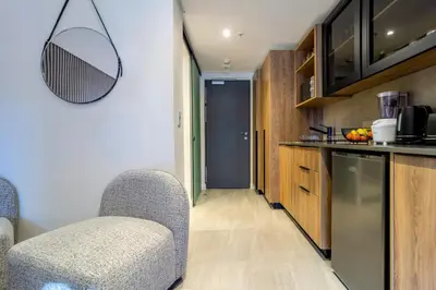 a kitchen with two chairs and a counter top at #AlimamaSpaces Manson's Menlyn Maine in Pretoria