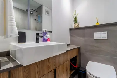 a bathroom with a white sink and a toilet at #AlimamaSpaces Manson's Menlyn Maine in Pretoria