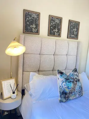 a bed with a pillow and a table with a lamp at Andisa Cozy Stay in Kempton Park