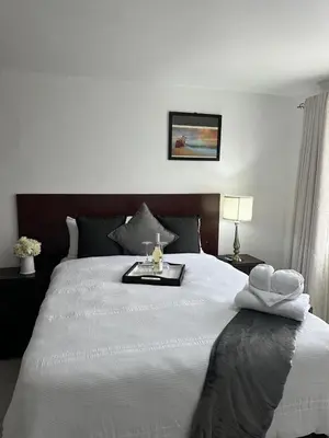 a bedroom with a large white bed with a tray on it at Green View Guest House Middelburg in Middelburg