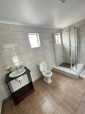 a bathroom with a toilet and a sink and a shower at Green View Guest House Middelburg in Middelburg