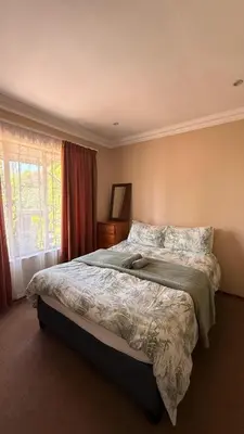 a bedroom with a large bed in a room at Contractor Stay Units in Middelburg