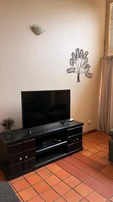 a flat screen tv sitting on top of a entertainment center at Contractor Stay Units in Middelburg