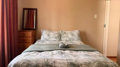 a bed with a stuffed animal laying on it at Contractor Stay Units in Middelburg
