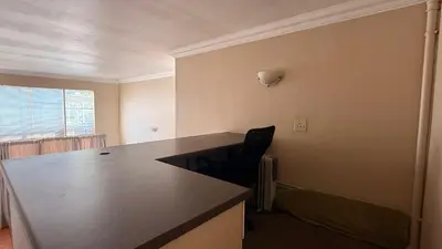 an empty room with a table and a chair at Contractor Stay Units in Middelburg