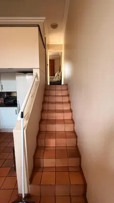 a staircase leading up to a room with a kitchen at Contractor Stay Units in Middelburg