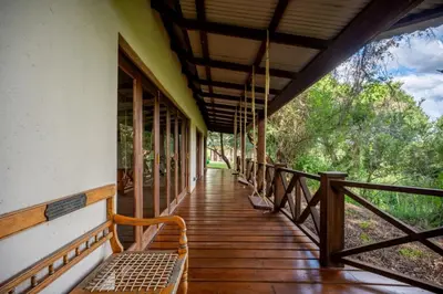a porch of a house with a bench on it at Ubungane Lodge in Makalali Game Reserve
