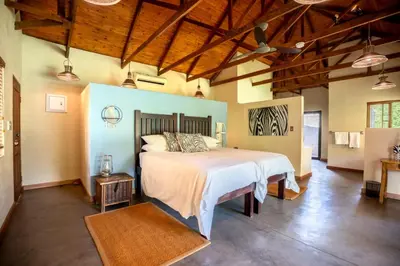 a bedroom with a large bed in a room at Ubungane Lodge in Makalali Game Reserve