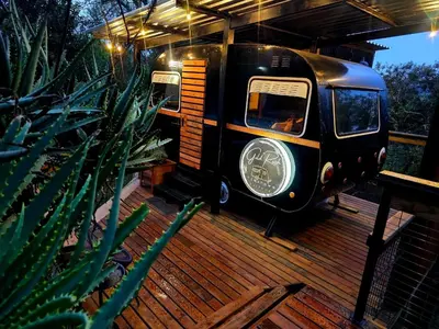 a black van parked on a wooden deck at Tin Town Glamping in Haenertsburg
