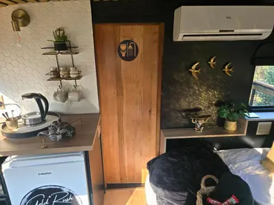 a room with a kitchen with a sink and a stove at Tin Town Glamping in Haenertsburg