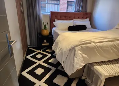 a bedroom with two beds and a window at Ibunami in Midrand