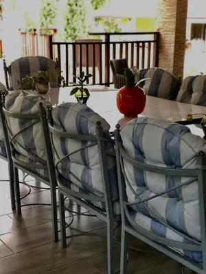 a table and chairs with a red apple on top at Royal Bliss Lodge and Spa in Midrand