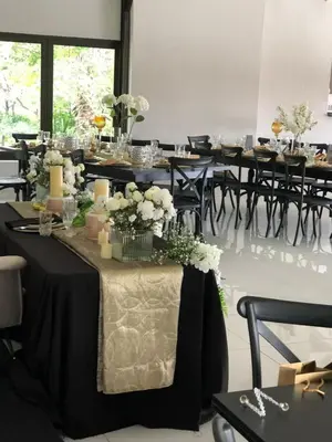 a dining room with tables with flowers and candles at Royal Bliss Lodge and Spa in Midrand