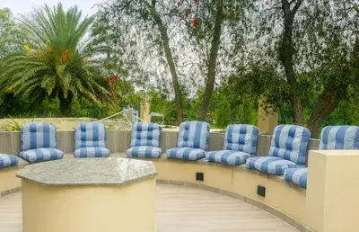 a row of blue chairs sitting on a deck at Royal Bliss Lodge and Spa in Midrand