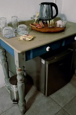 a table with a tea kettle on top of it at Golden Stay Guest House in Nelspruit
