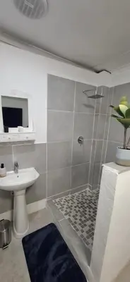 a bathroom with a shower and a sink at Golden Stay Guest House in Nelspruit