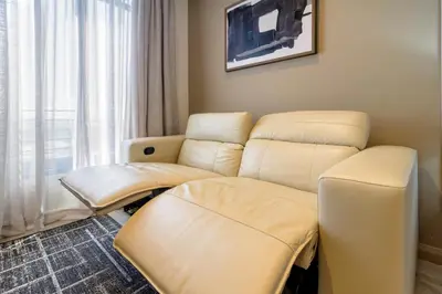 a hospital room with a couch and a chair at #AlimamaSpaces The Nook Menlyn Maine Studio in Pretoria
