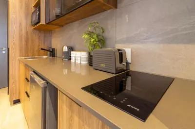 a kitchen counter with a toaster and a microwave at #AlimamaSpaces The Nook Menlyn Maine Studio in Pretoria