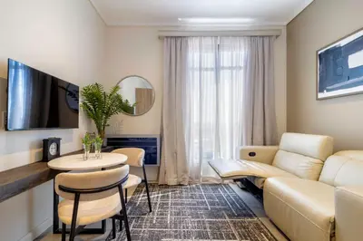 a living room with a couch and a table at #AlimamaSpaces The Nook Menlyn Maine Studio in Pretoria