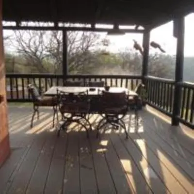 a patio with a table and chairs on a deck at Hazyview Country Estate in Swartfontein
