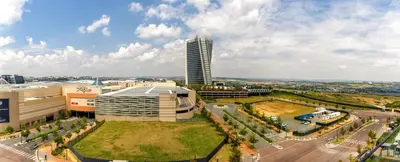 an aerial view of a building with a tall tower at #AlimamaSpaces The Phum's Ellipse in Midrand