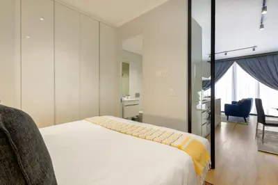 a bedroom with a bed and a desk and a chair at #AlimamaSpaces The Ace's Ellipse in Midrand