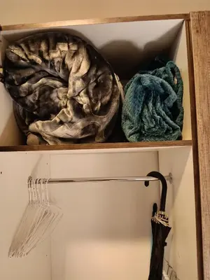 two towels and an umbrella on a shelf at Cozy Corner Cottage near wilgers hospital & Menlyn in Pretoria