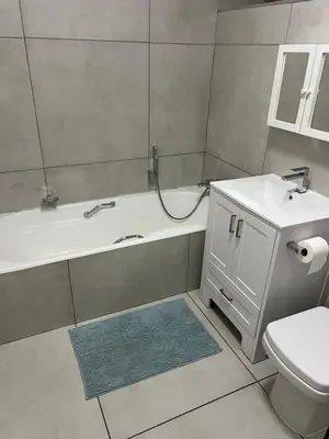 a bathroom with a tub and a toilet and a sink at 458 on Manitoba in Pretoria