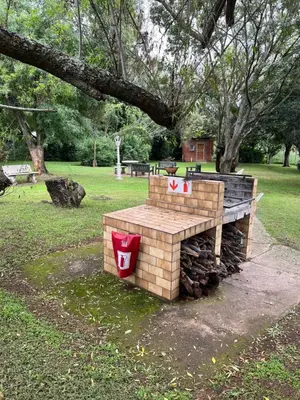 a fire pit in a park with two signs on it at 458 on Manitoba in Pretoria