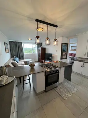a kitchen and living room with a stove top oven at 458 on Manitoba in Pretoria