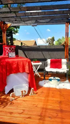 a bedroom with a red and white bed on a wooden floor at Palma Spaces in Pretoria