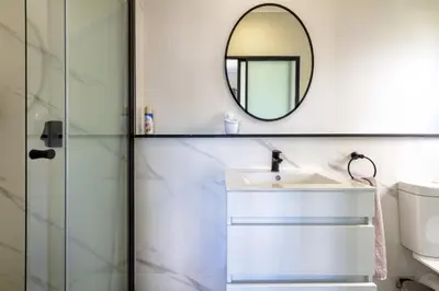 a bathroom with a sink and a mirror at #AlimamaSpaces The Rob's Munyaka in Midrand