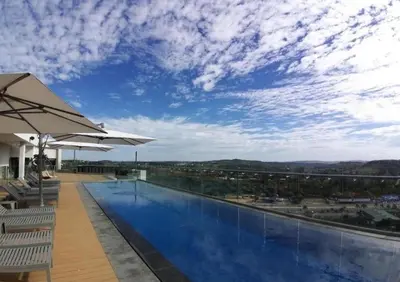 a swimming pool with a view of the sky at 1606 Menlyn Maine Residence Luxury Apartments in Pretoria
