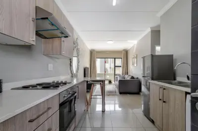 a kitchen with a stove and a counter top at #AlimamaSpaces The Manson's Heights in Midrand