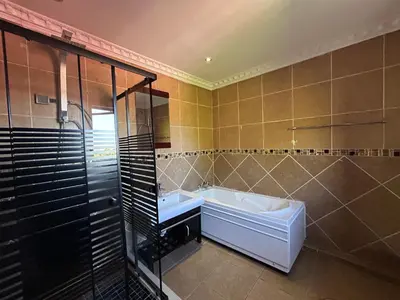 a bathroom with a tub and a sink and a shower at Homely Palace in Midrand