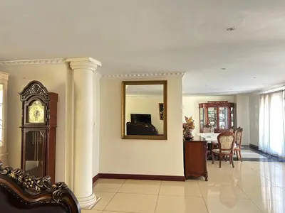 a living room with a clock and a mirror at Homely Palace in Midrand