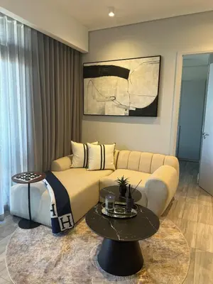 a living room with a couch and a table at Stylish Dante Trilogy Menlyn Maine Apartment in Pretoria