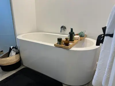 a bathroom with a bath tub with a sink at Stylish Dante Trilogy Menlyn Maine Apartment in Pretoria